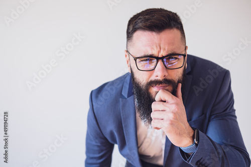 Portrait of businessman who is thoughtful and worried. Copy space on image for your text or advert.