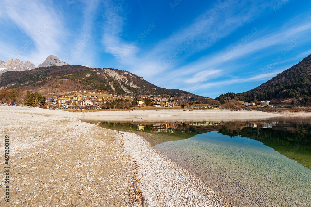 Molveno village, tourist resort on the coastline of the Molveno lake with the mountain range of Brenta Dolomites in winter. National Park of Adamello Brenta. Trentino Alto Adige, Trento, Italy, Europe