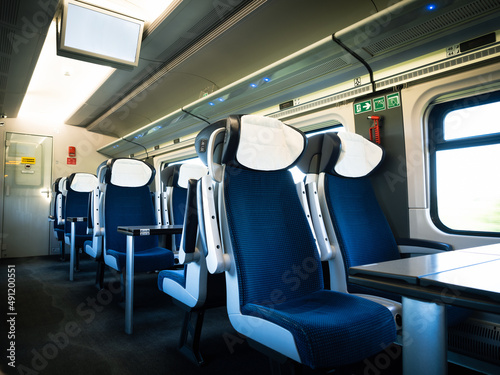 modern interior of an empty train carriage with seats