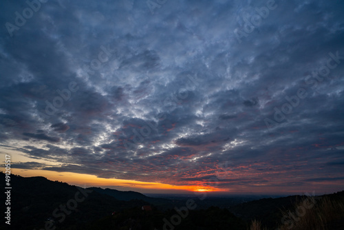 nature sunset landscape scene view  panorama natural view for using in background or concept of environmental and sustainable development  The sun downing over the cloud sky and local mountain land