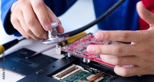 Repairman working in technical support fixing computer laptop tr