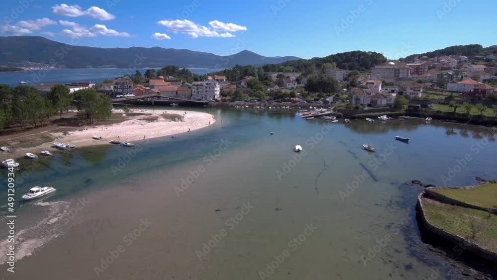 Aerial View Over Esteiro Bay With Boats Moored And Beach Pavillion. Dolly Back Aerial View Over Esteiro Bay With Boats Moored And Beach Pavillion. Dolly Back