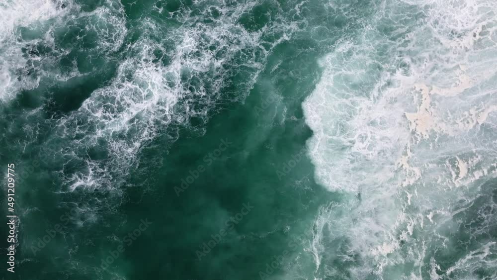 Mesmerizing shot of waves crashing on a beach view from above. Mesmerizing shot of waves crashing on a beach view from above.