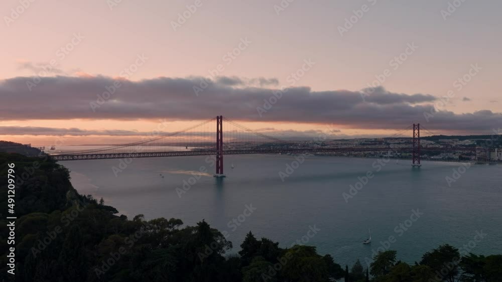 Large shot of the bridge of 25 April in Lisboa during sunset with the Almada at the front. Large shot of the bridge of 25 April in Lisboa during sunset with the Almada at the front.