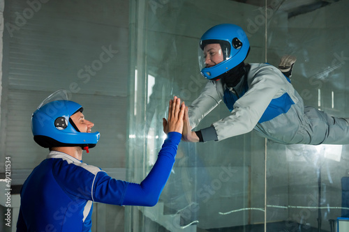 A man trains a woman as an astronaut. Classes on flying in a wind tunnel.