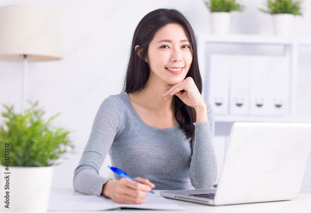 Young businesswoman using laptop and working at home office Young businesswoman using laptop and working at home office