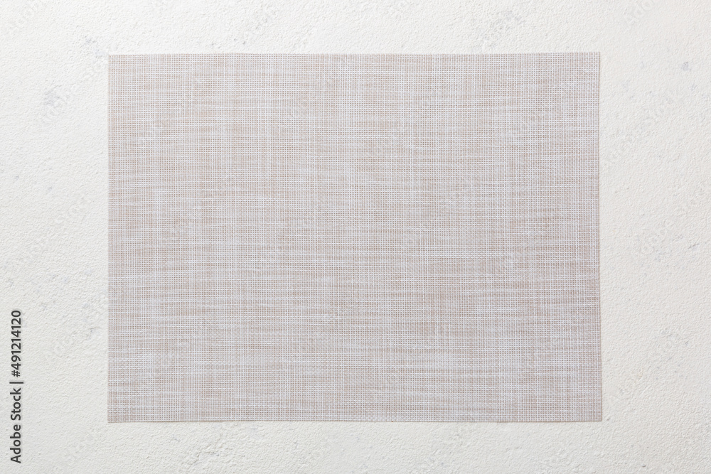 Fototapeta premium Top view of grey tablecloth for food on cement background. Empty space for your design