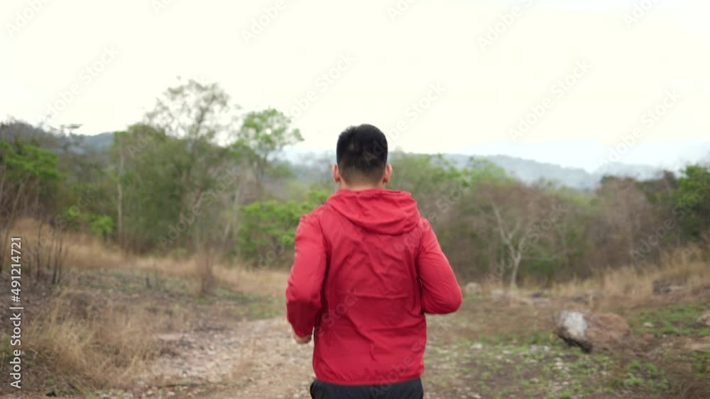 Smart trail runner man running on rocky mountain. Athlete jog, exercising outdoor for healthy. Confident and powerful marathon man running workout and cardio. Sport and Lifestyle concept. Smart trail runner man running on rocky mountain. Athlete jog, exercising outdoor for healthy. Confident and powerful marathon man running workout and cardio. Sport and Lifestyle concept.