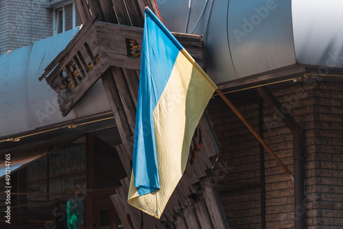 The national flag of Ukraine flutters in the wind. The national symbol of the Ukrainian people on the building. City Dnipro