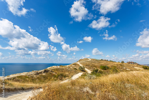 Beautiful landscape of high coast  blue sea and fluffy clouds on a sunny summer day. The Black Sea coast. Anapa