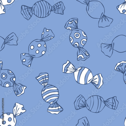 Seamless vector pattern with wrapped candy on blue background. Simple hand drawn sweets wallpaper design. Decorative cartoon fashion textile.