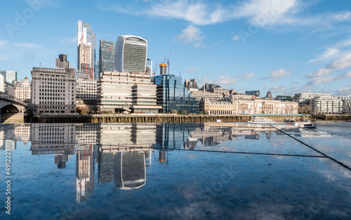 London reflections. The skyscrapers and modern architecture of the City of London business and financial district mirrored on smooth polished marble.