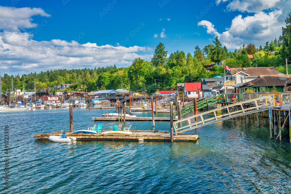 Cowichan Bay boats and wooden homes on a beautiful summer day, Vancouver Island - Canada.