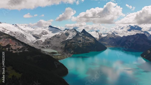 Moving clouds above Garibaldi Lake in Canada, British Columbia, aerial drone view of beautiful nature around photo