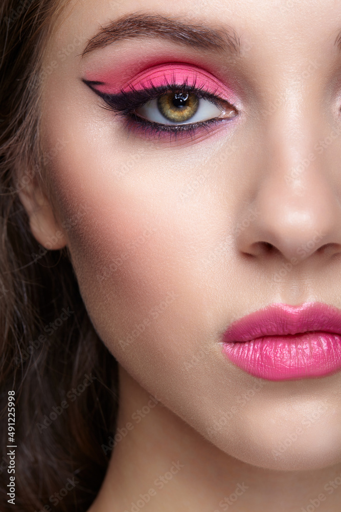 Closeup macro shot of human female face with pink makeup Closeup macro shot of human female face with pink makeup