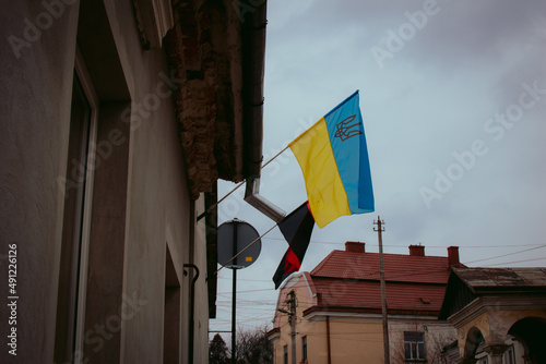 State flag of Ukraine (yellow and blue) and revolutionary flag of Organization of Ukrainian Nationalists (red and black). Stand up with Ukraine! Stop putin!