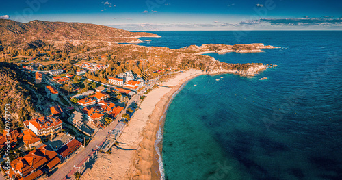 Visit Kalamitsi beach in Greece. Aerial view of the idyllic seascape on the Sithonia peninsula in Halkidiki. High above the roofs of the resort village with villas and hotels. photo