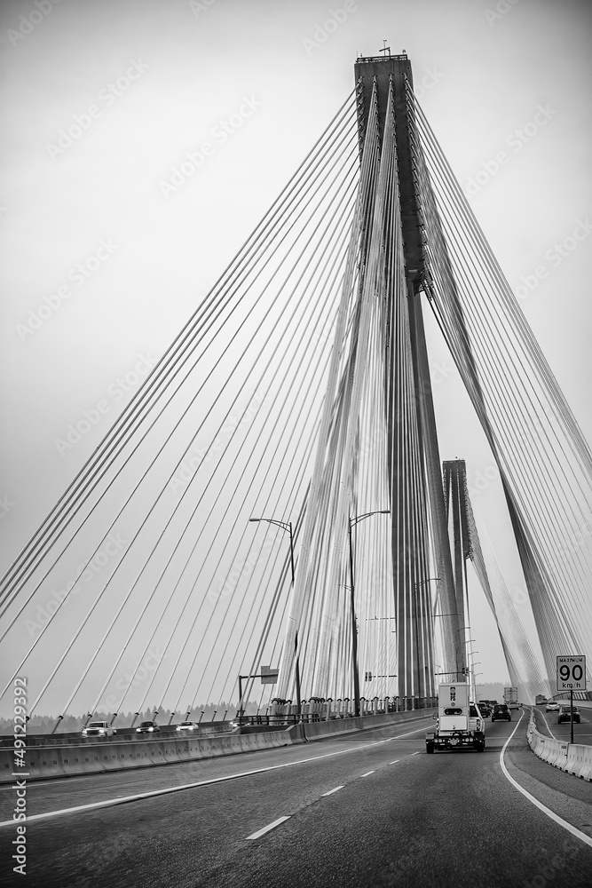 Obraz premium British Columbia, Canada - August 8, 2017: Road traffic on a bridge towards Vancouver.