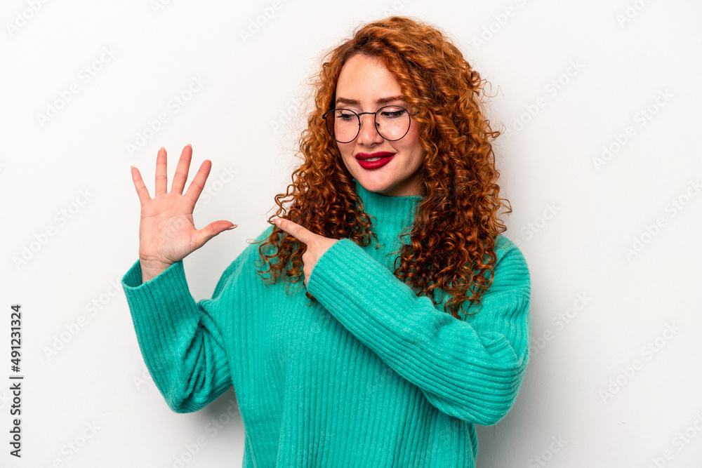 Young ginger caucasian woman isolated on white background smiling cheerful showing number five with fingers. Young ginger caucasian woman isolated on white background smiling cheerful showing number five with fingers.