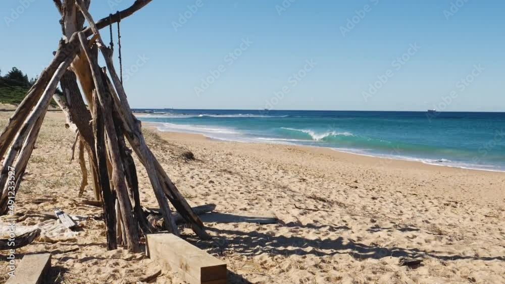 Slow motion landscape shot of wood branch sculpture on sandy with shore-beak wave crystal clear beautiful Shelly Beach NSW Central Coast Australia HD Slow motion landscape shot of wood branch sculpture on sandy with shore-beak wave crystal clear beautiful Shelly Beach NSW Central Coast Australia HD