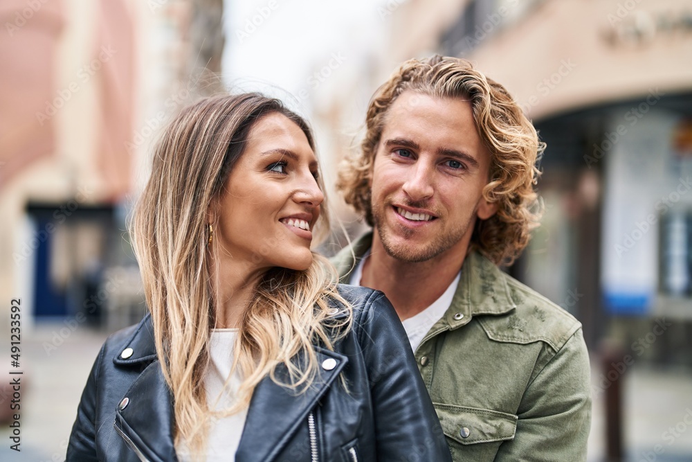 Man and woman couple smiling confident hugging each other at street Man and woman couple smiling confident hugging each other at street