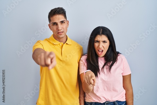Young couple standing over isolated background pointing displeased and frustrated to the camera, angry and furious with you © Krakenimages.com