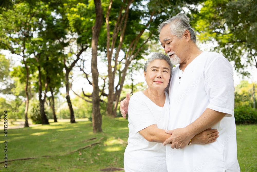 Happy asian elderly couple yoga exercise health care in park, Lovely asian seniors couple embracing together in the morning. Happy asian elderly couple yoga exercise health care in park, Lovely asian seniors couple embracing together in the morning.
