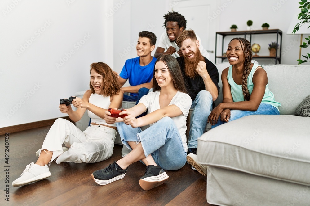 Group of young friends smiling happy playing video game at home. Group of young friends smiling happy playing video game at home.