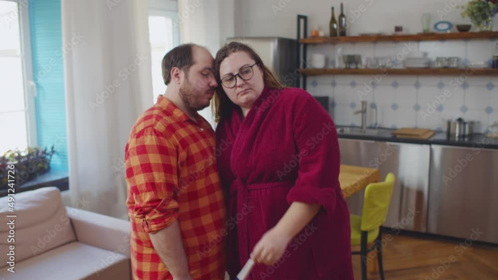 Overweight sad couple looking at pregnancy test. Realtime Overweight sad couple looking at pregnancy test. Realtime