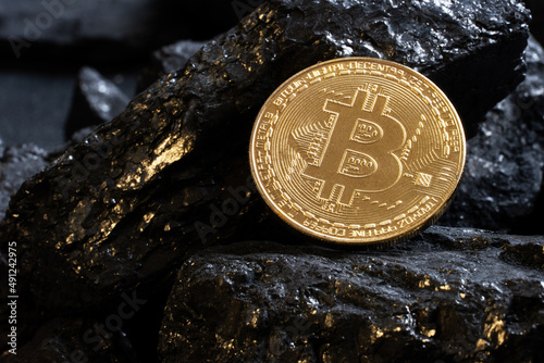 Gold coin bitcon and coal.