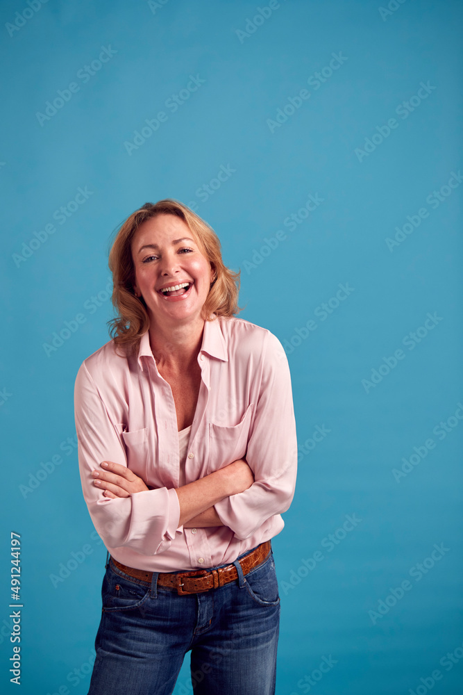 Portrait Of Mature Female Model Posing For Photographer Against Background On Studio Fashion Shoot Portrait Of Mature Female Model Posing For Photographer Against Background On Studio Fashion Shoot