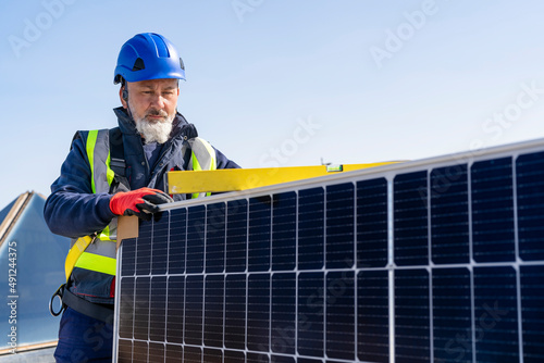 Wallpaper Mural Technician with helmet working with solar panel Torontodigital.ca