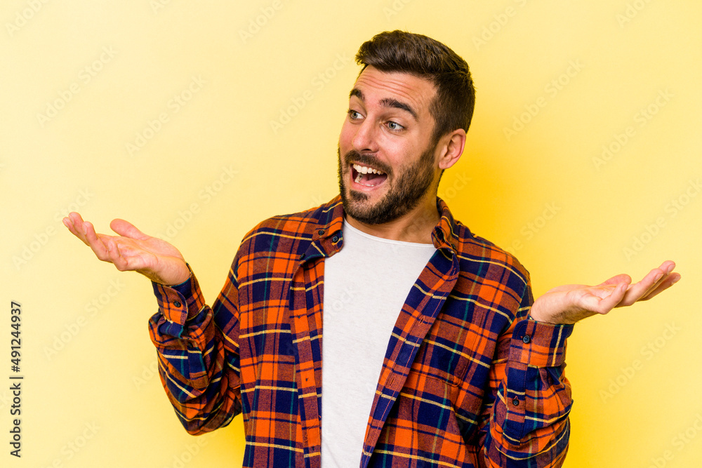 Young caucasian man isolated on yellow background joyful laughing a lot. Happiness concept. Young caucasian man isolated on yellow background joyful laughing a lot. Happiness concept.