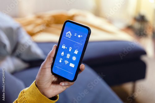 Woman using mobile app in living room photo