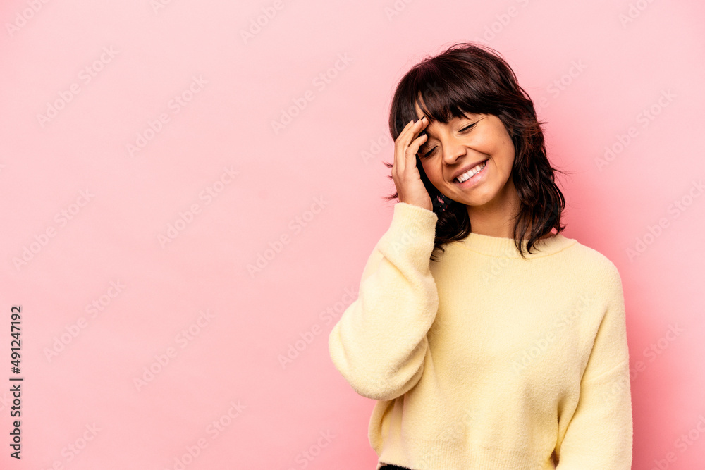 Young hispanic woman isolated on pink background laughing happy, carefree, natural emotion. Young hispanic woman isolated on pink background laughing happy, carefree, natural emotion.