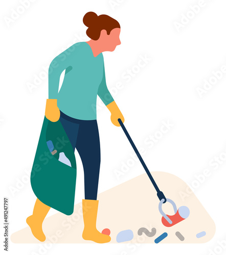 Woman picking garbage with stick. Activist cleaning nature