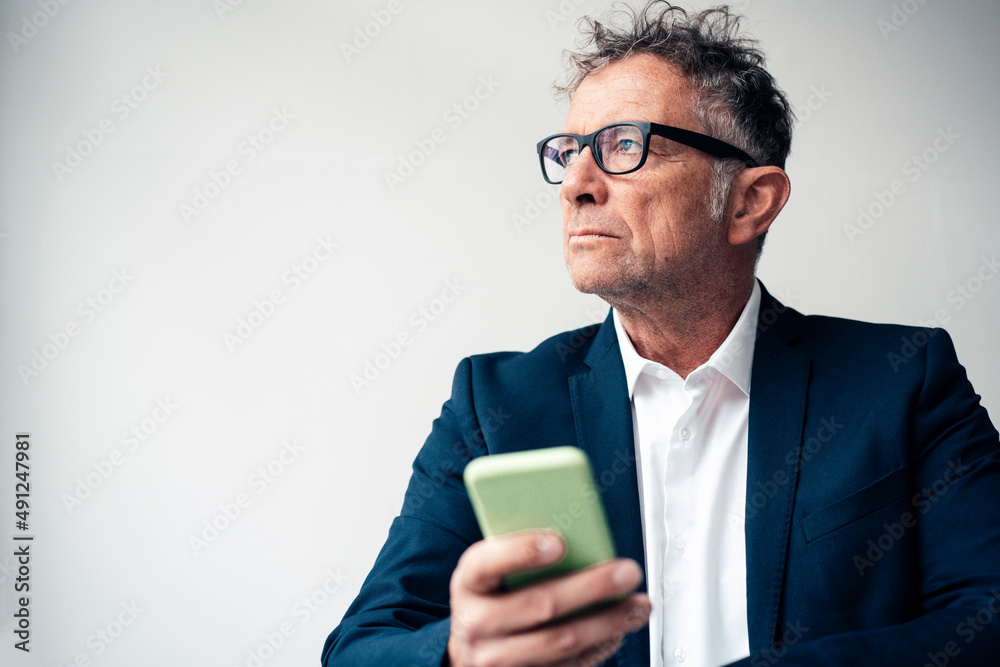 Businessman with mobile phone against white background Businessman with mobile phone against white background