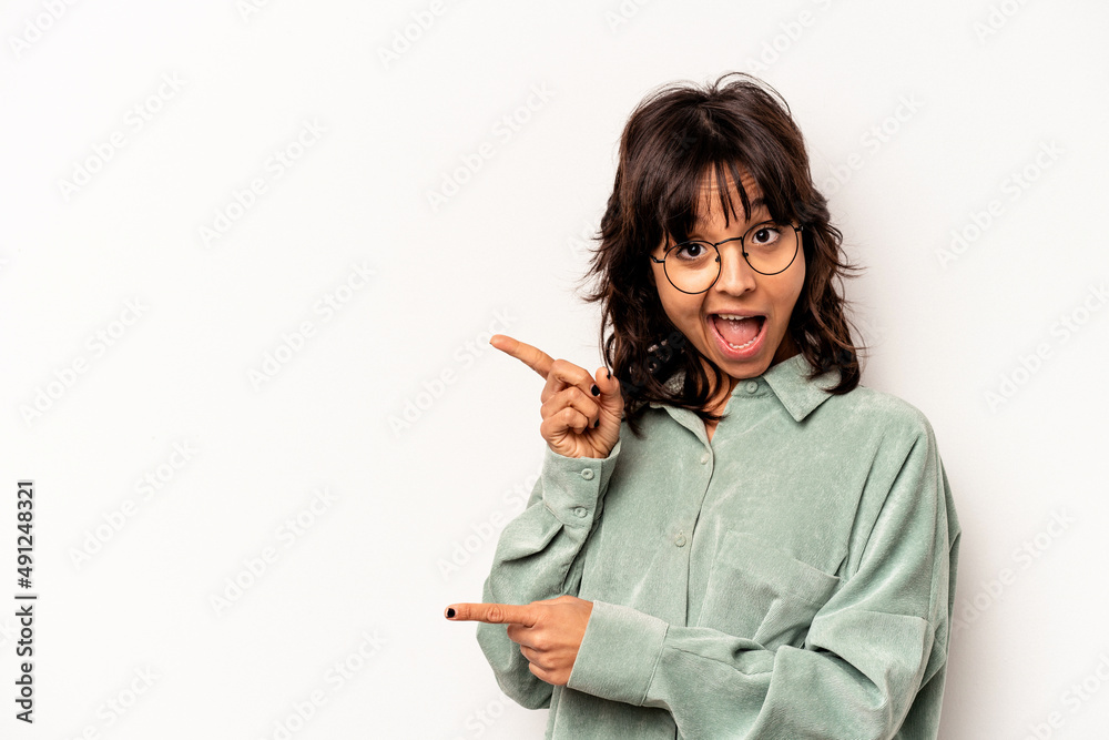 Young hispanic woman isolated on white background pointing with forefingers to a copy space, expressing excitement and desire. Young hispanic woman isolated on white background pointing with forefingers to a copy space, expressing excitement and desire.