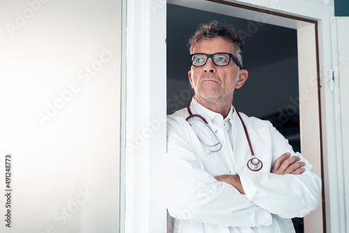 General practitioner with arms crossed in clinic photo