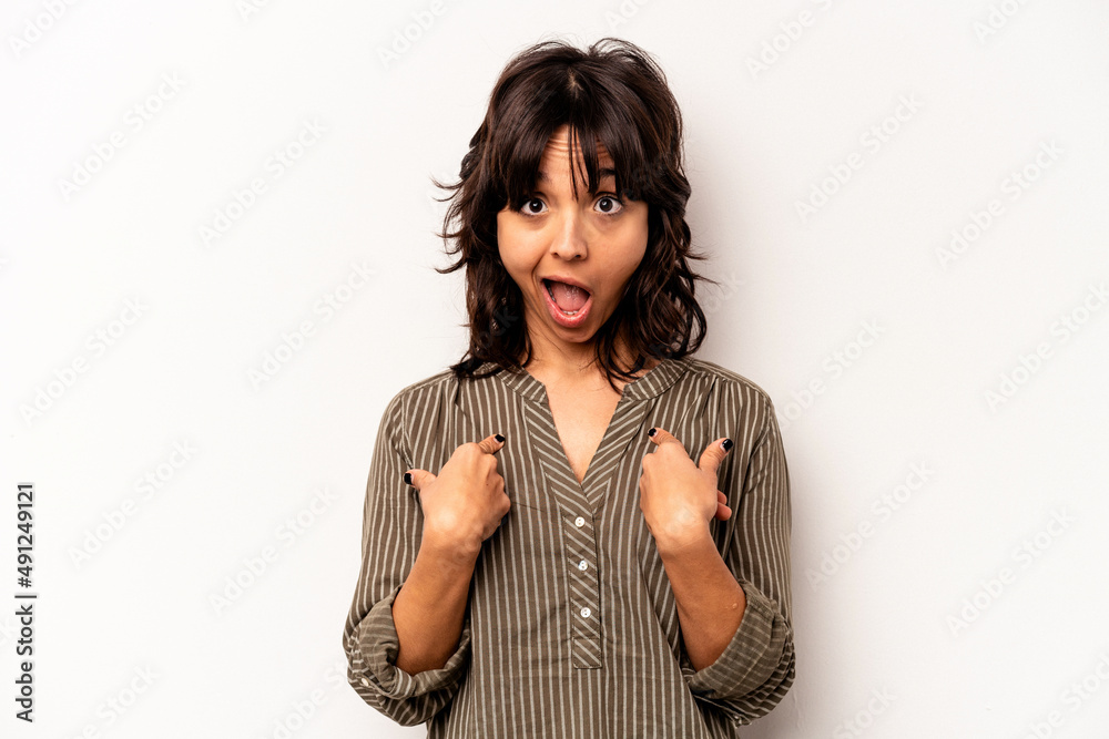 Young hispanic woman isolated on white background surprised pointing with finger, smiling broadly. Young hispanic woman isolated on white background surprised pointing with finger, smiling broadly.