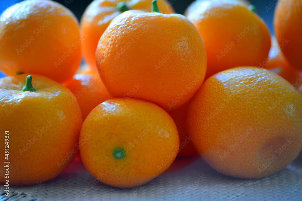 Ripe tangerines are on the table. The ripening season of tropical citrus fruits. Close-up. Ripe tangerines are on the table. The ripening season of tropical citrus fruits. Close-up.