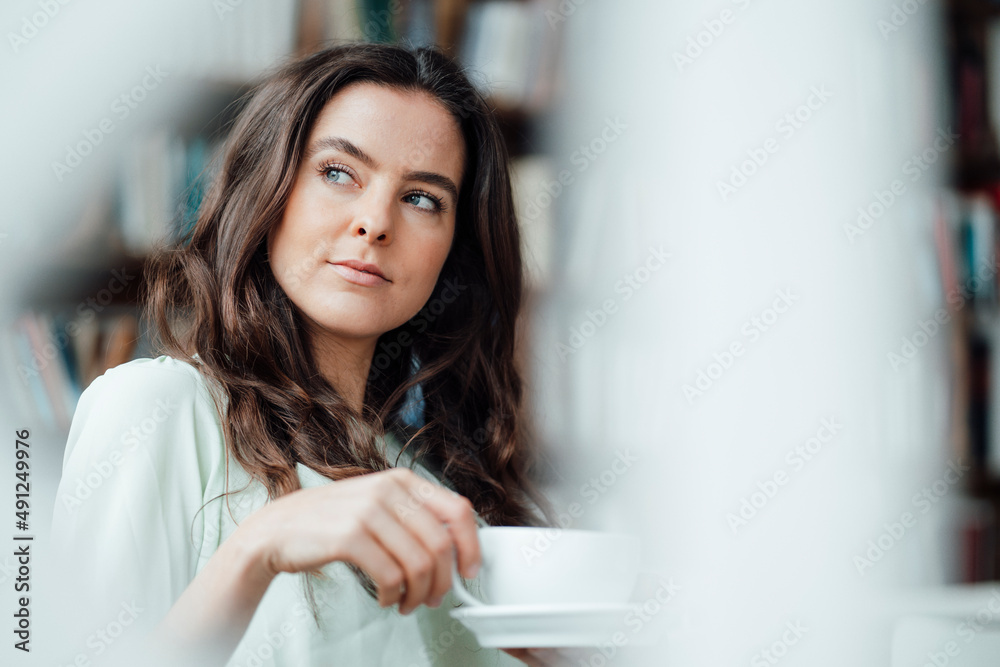 Thoughtful woman with coffee cup in cafe Thoughtful woman with coffee cup in cafe