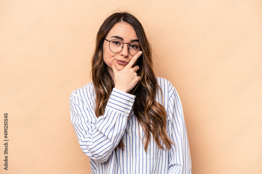 Young caucasian woman isolated on beige background contemplating, planning a strategy, thinking about the way of a business. Young caucasian woman isolated on beige background contemplating, planning a strategy, thinking about the way of a business.