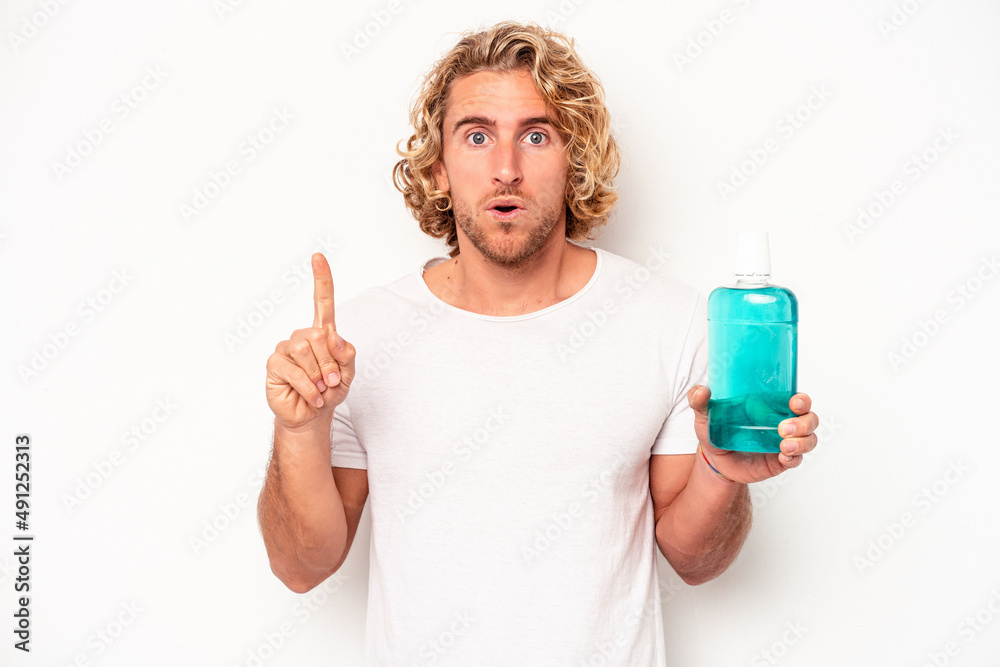 Young caucasian man holding a clapperboard isolated on white background having some great idea, concept of creativity. Young caucasian man holding a clapperboard isolated on white background having some great idea, concept of creativity.