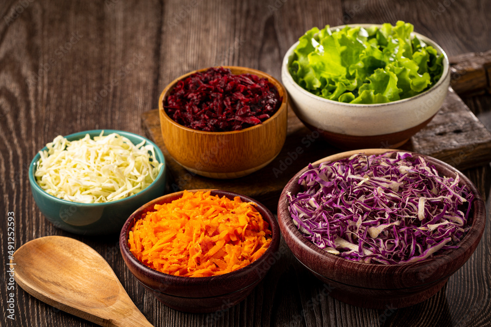 Fresh grated vegetables in bowls on the table. Healthy food.