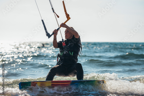 Woman kitesurfing on the ocean waters
