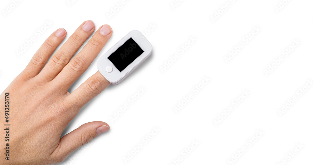 Top view of pulse oximeter on finger to measuring saturation oxygen level and pulse rate isolated on white background, copy space. Top view of pulse oximeter on finger to measuring saturation oxygen level and pulse rate isolated on white background, copy space.