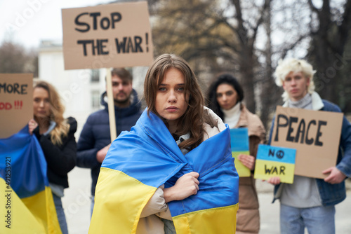 Fototapeta Group of young caucasian people manifesting against war in Ukraine