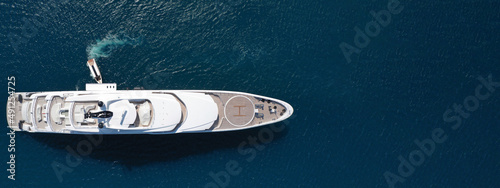 Aerial drone ultra wide panoramic photo of luxury yacht with wooden deck anchored in Mediterranean open ocean deep blue bay © aerial-drone