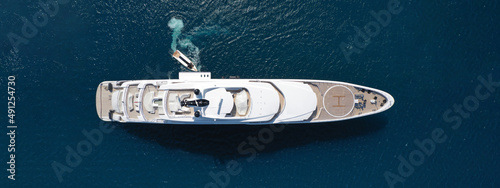 Tableau sur toile Aerial drone ultra wide top down photo of large yacht with wooden deck anchored